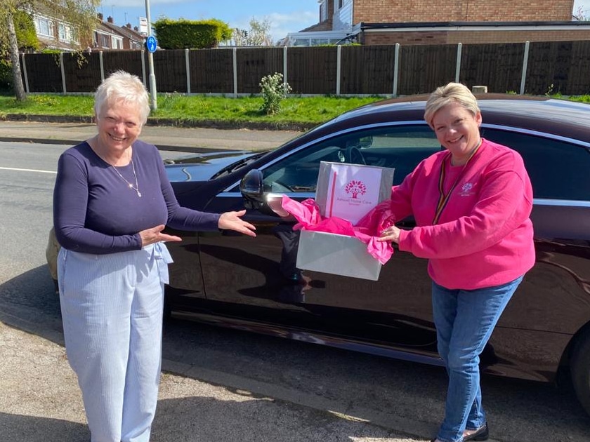 Margaret Lowe hands gift boxes to Debbie Ashwell